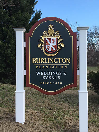 BURLINGTON PLANTATION CHARLES CITY, VA FREE STANDING ENTRY SIGN FOR HISTORIC PROPERTY 7’ X 4’ HDU SIGN FACE WITH PRISMATIC INCISED & GOLD LEAFED COPY. ADDITIONAL APPLIED CARVED FAMILY CREST IS ALSO GOLD LEAFED. POSTS ARE PVC CLAD WOOD WITH PVC CROWN MOLDING & PVC BASES.