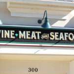 STOREFRONT WALL SIGN, ROUTED WITH RAISED PRISMATIC GOLD-LEAF LETTERING, BLACK SMALTS BKG, POWHATAN, VA