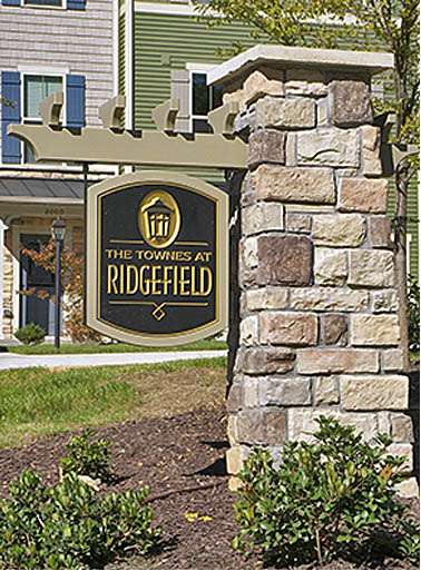 RIDGE FIELD CONDOMINIUMS CHESTERFIELD, VA CRAFTSMAN STYLE STONE MASONRY HANGING ENTRY SIGN WITH 3’ X 2’ ROUTED FACES, 3D PRISMATIC ROUTED COPY & CUSTOM FABRICATED PVC TRELLIS / HANGER STRUCTURE
