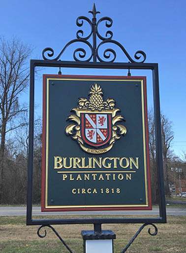 ANTIQUE COLONIAL-STYLE VENUE ENTRANCE SIGN, PRISMATIC INCISED AND GOLD-LEAF LETTERS, GOLD LEAF CARVED FAMILY CREST, WROUGHT IRON BRACKET WITH PVC PYLON, CHARLES CITY, VA